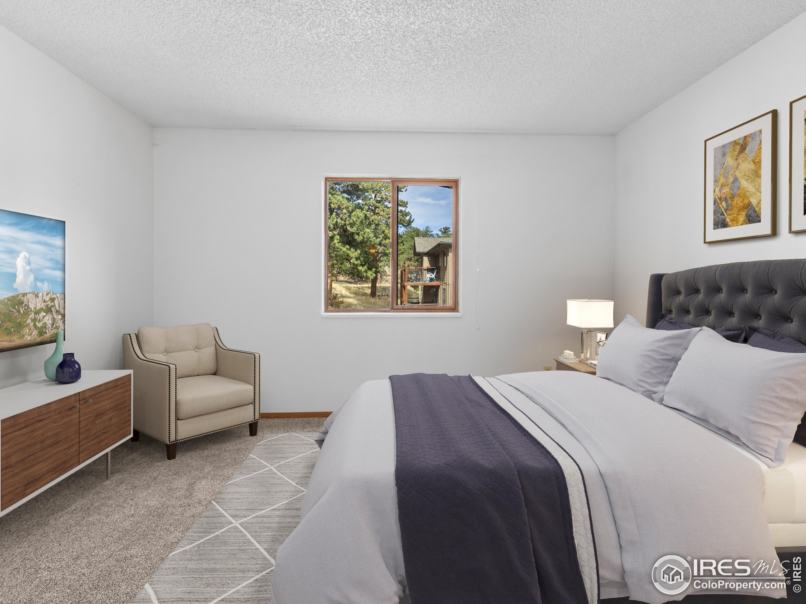 1155 South St Vrain Avenue, Unit 13 Estes Park, CO 80517 - Photo 9 of 18 a bedroom with a bed and a couch