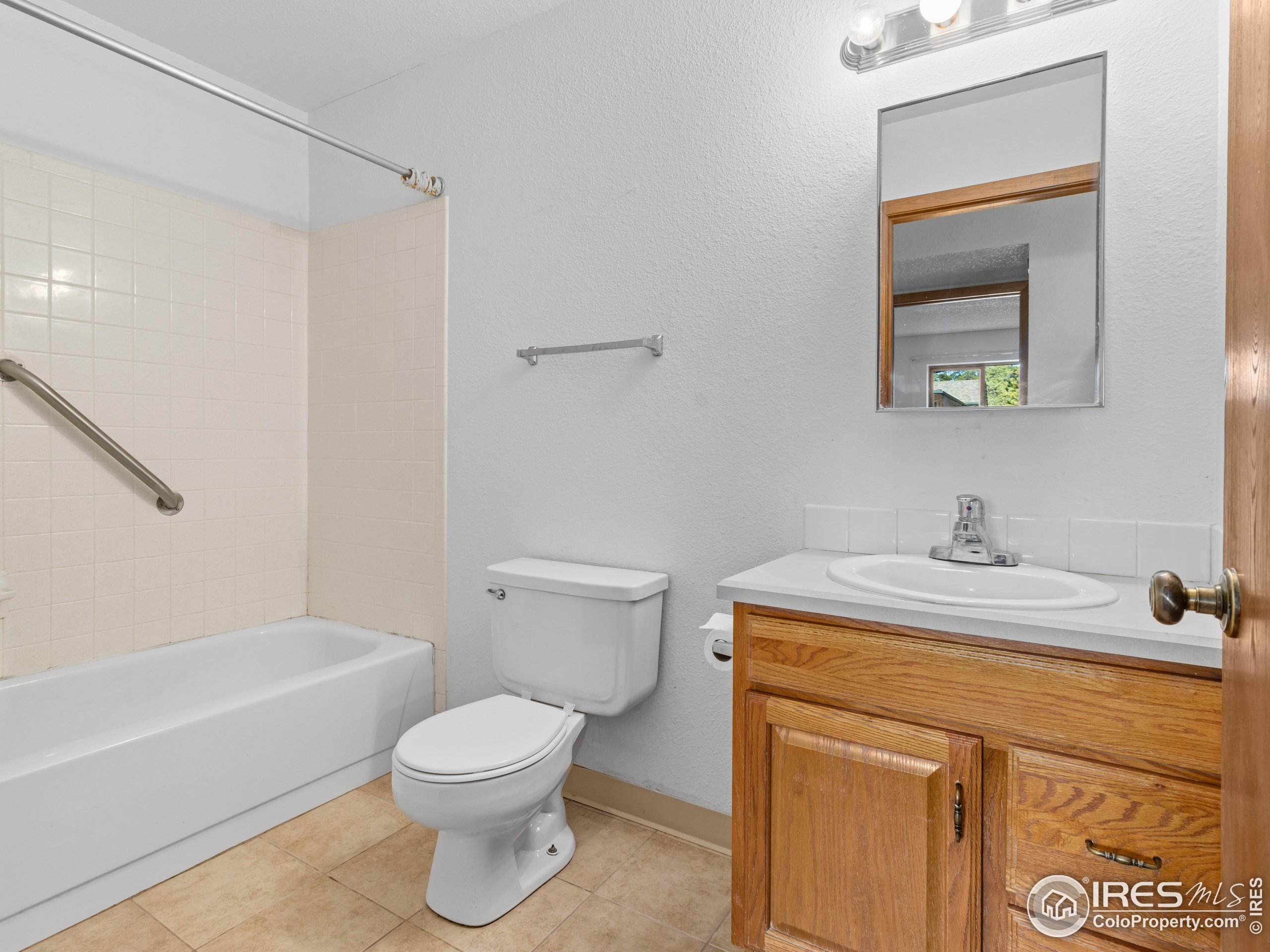 1155 South St Vrain Avenue, Unit 13 Estes Park, CO 80517 - Photo 10 of 18 a bathroom with a sink a toilet and shower