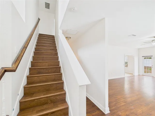 a view of entryway and hall with wooden floor