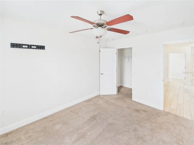 a view of a room with a ceiling fan