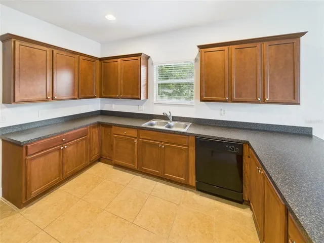 a kitchen with sink cabinets and window