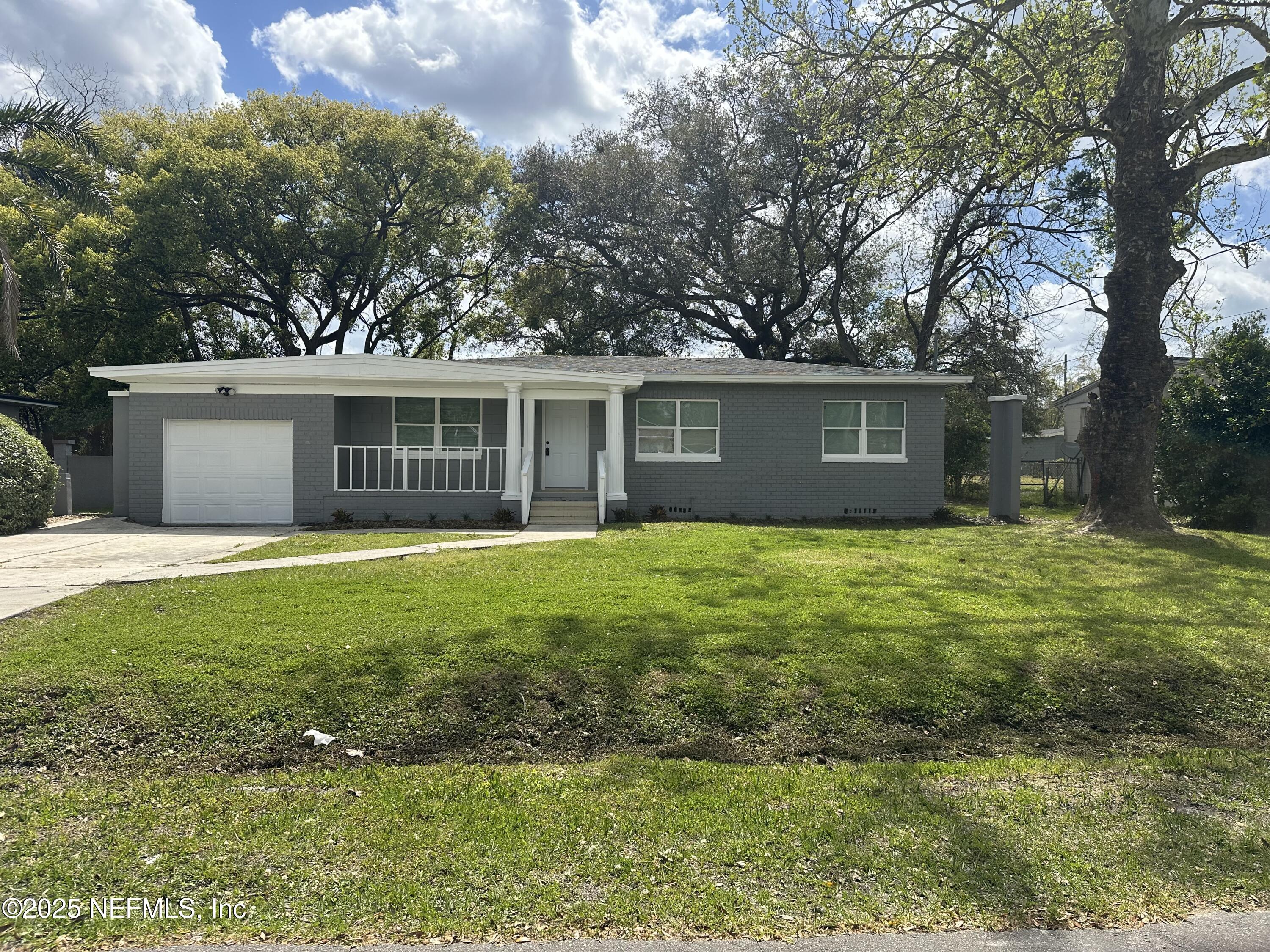 8049 Ramsgate Road Jacksonville, FL 32208 - Photo 1 of 14 a front view of house with yard and green space
