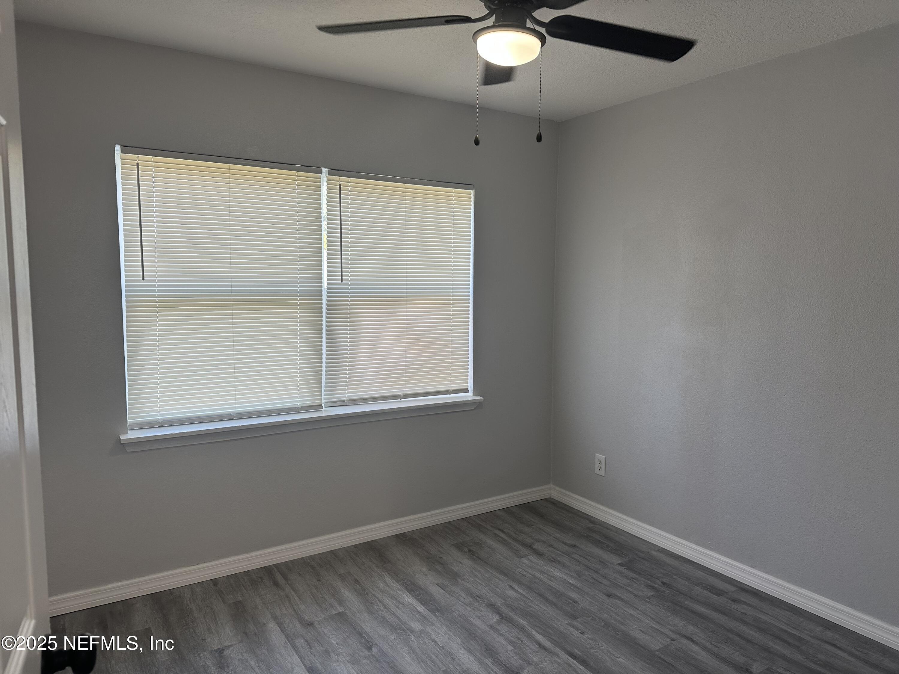8049 Ramsgate Road Jacksonville, FL 32208 - Photo 11 of 14 an empty room with a window