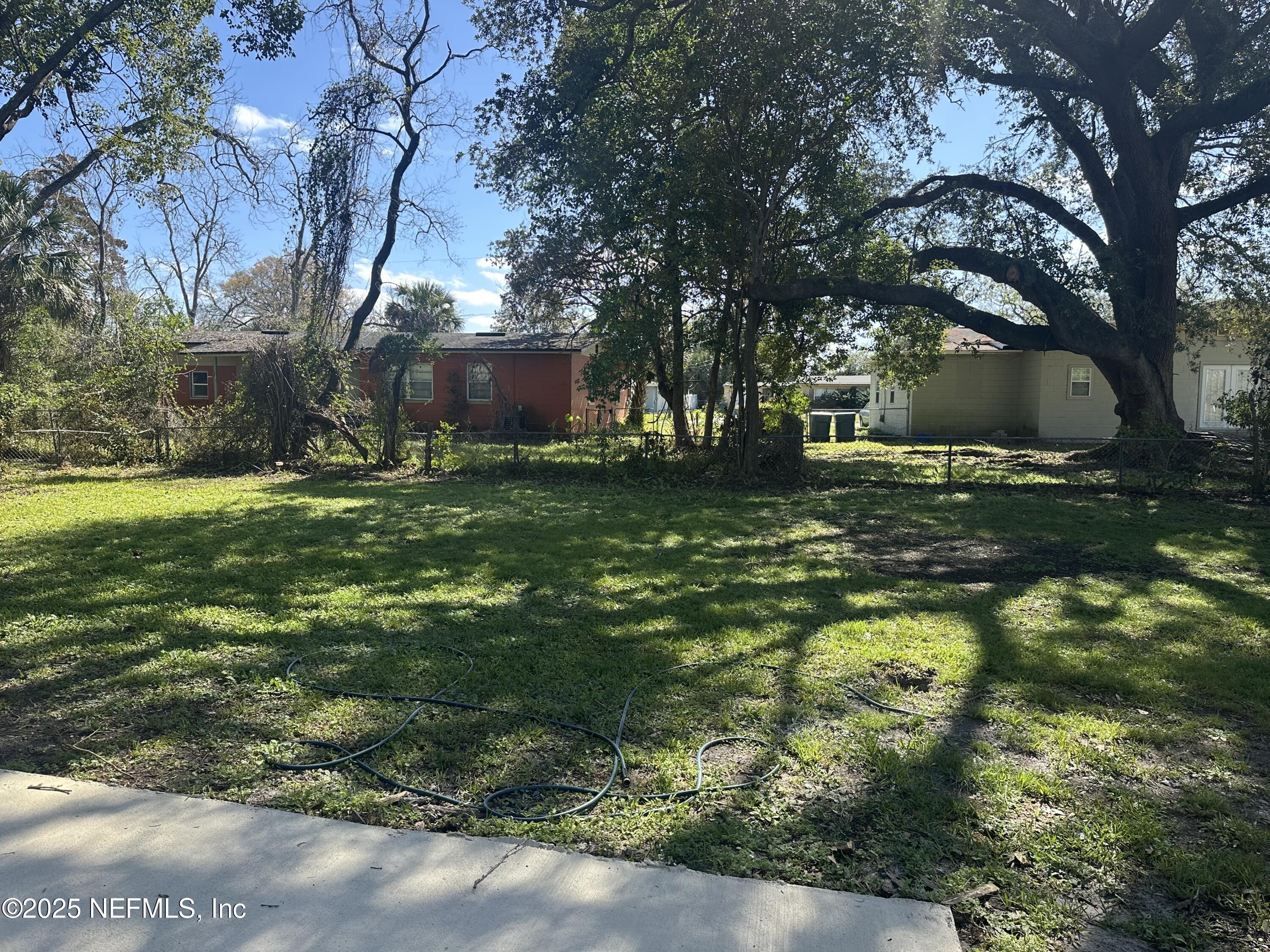 8049 Ramsgate Road Jacksonville, FL 32208 - Photo 14 of 14 a backyard of a house with lots of green space