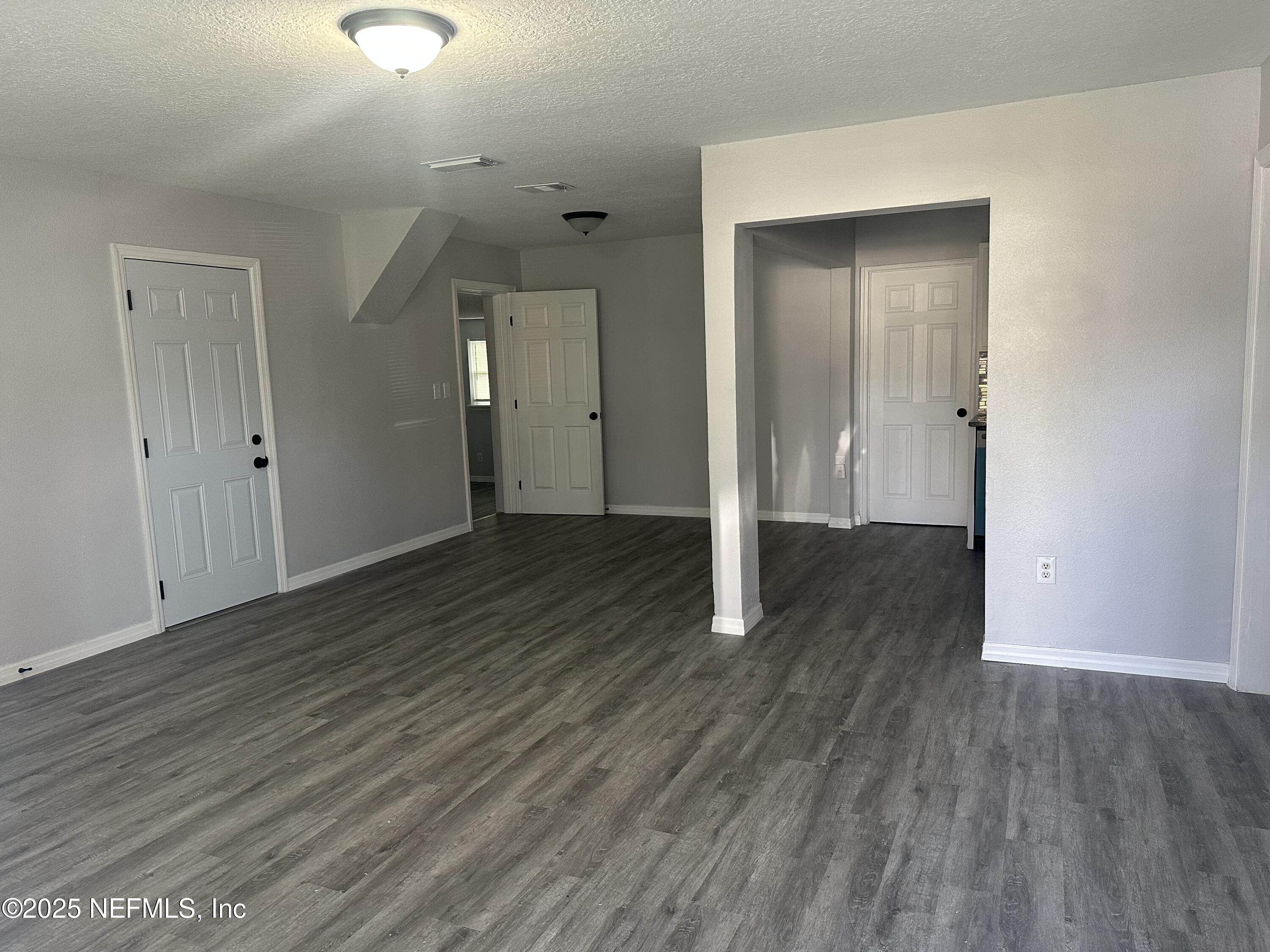 8049 Ramsgate Road Jacksonville, FL 32208 - Photo 4 of 14 wooden floor in an empty room with wooden floor
