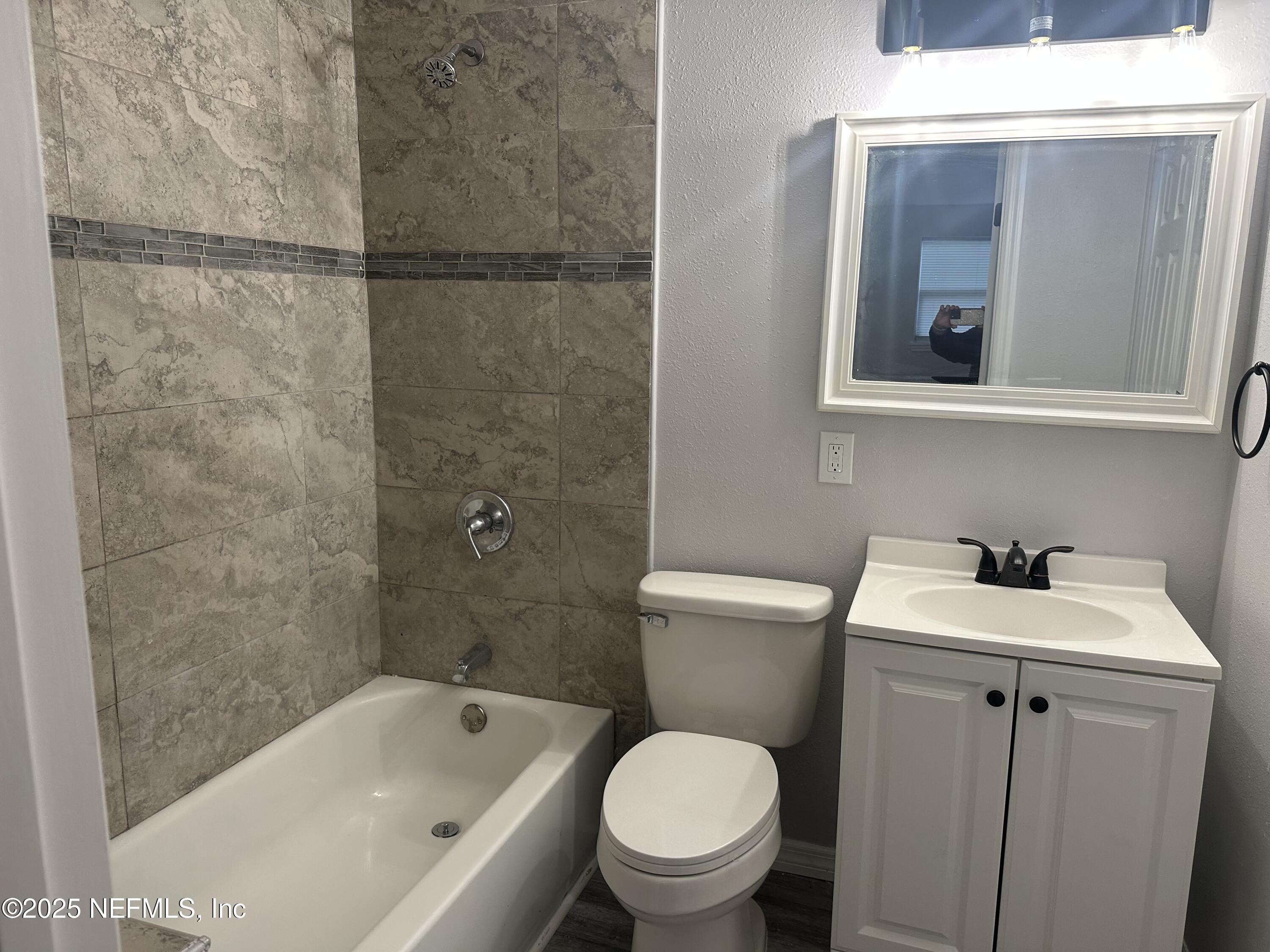 8049 Ramsgate Road Jacksonville, FL 32208 - Photo 8 of 14 a bathroom with a sink toilet and shower