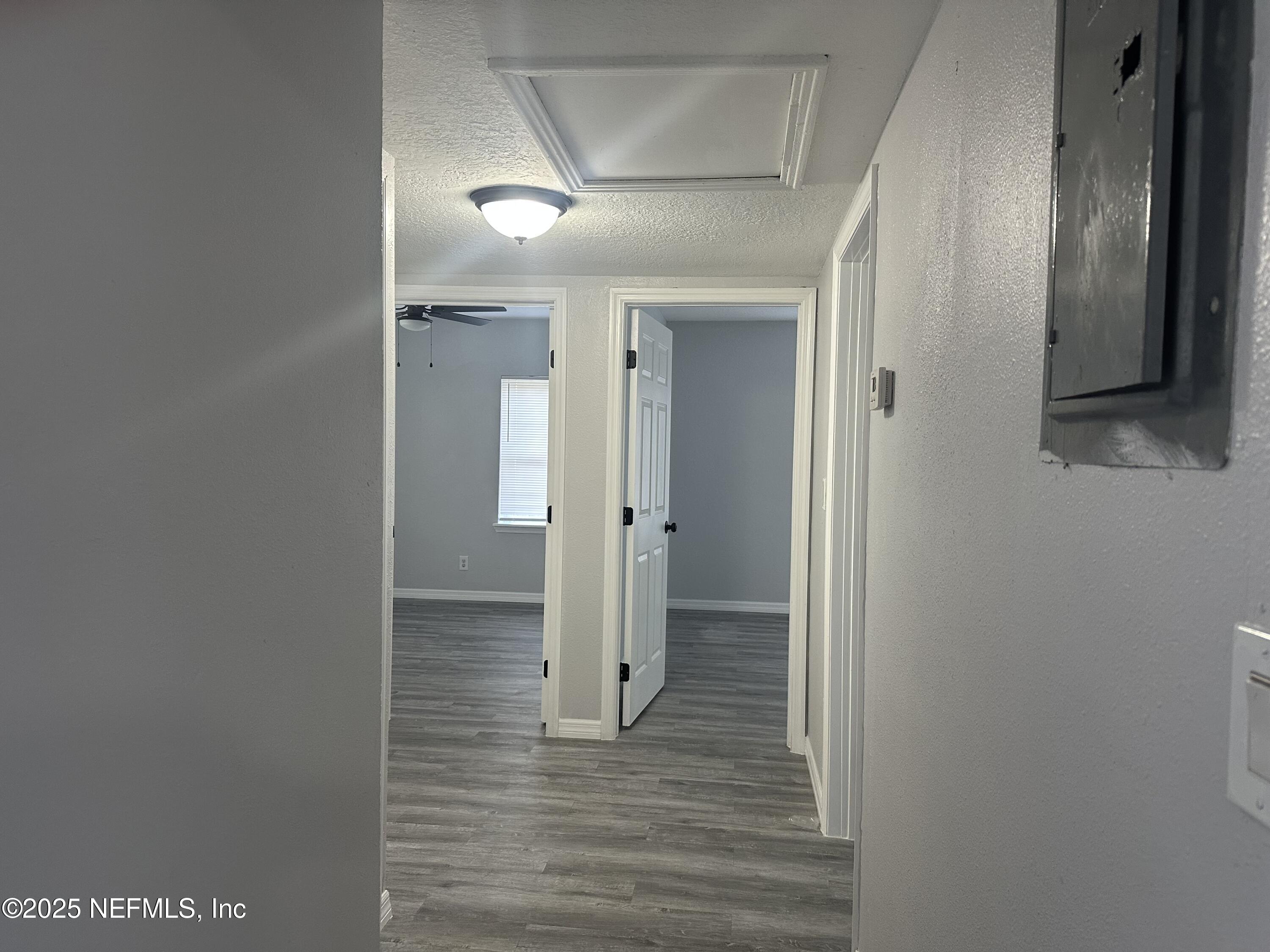 8049 Ramsgate Road Jacksonville, FL 32208 - Photo 9 of 14 a view of a hallway with wooden floor