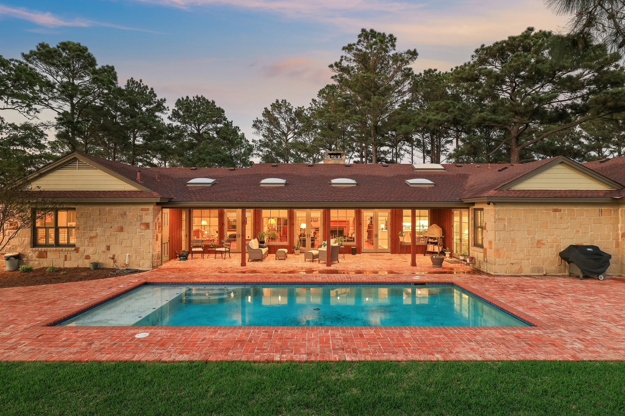 546 McAllister Road Bastrop, TX 78602 - Photo 1 of 40 Back of house featuring a patio, an outdoor pool, stone siding, and an outdoor living space