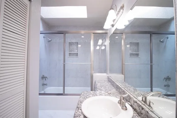 a bathroom with a double vanity sink and a mirror