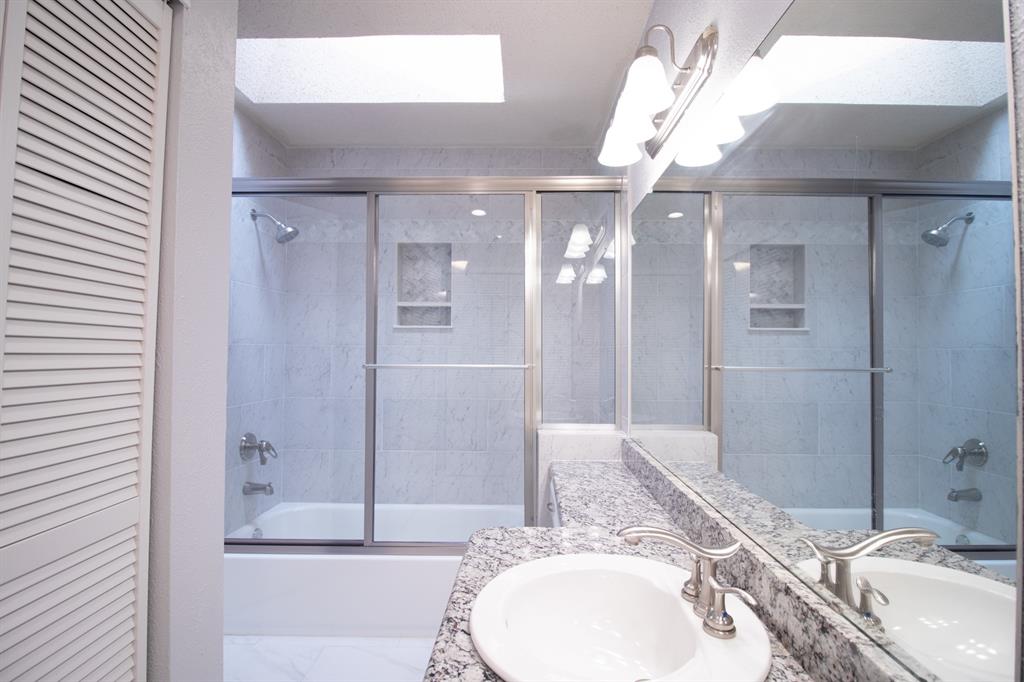 4777 Cedar Springs Road, Unit 4D Dallas, TX 75219 - Photo 14 of 20 a bathroom with a sink and a mirror