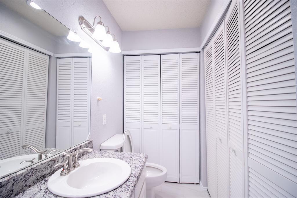 4777 Cedar Springs Road, Unit 4D Dallas, TX 75219 - Photo 15 of 20 a bathroom with a double vanity sink and a mirror