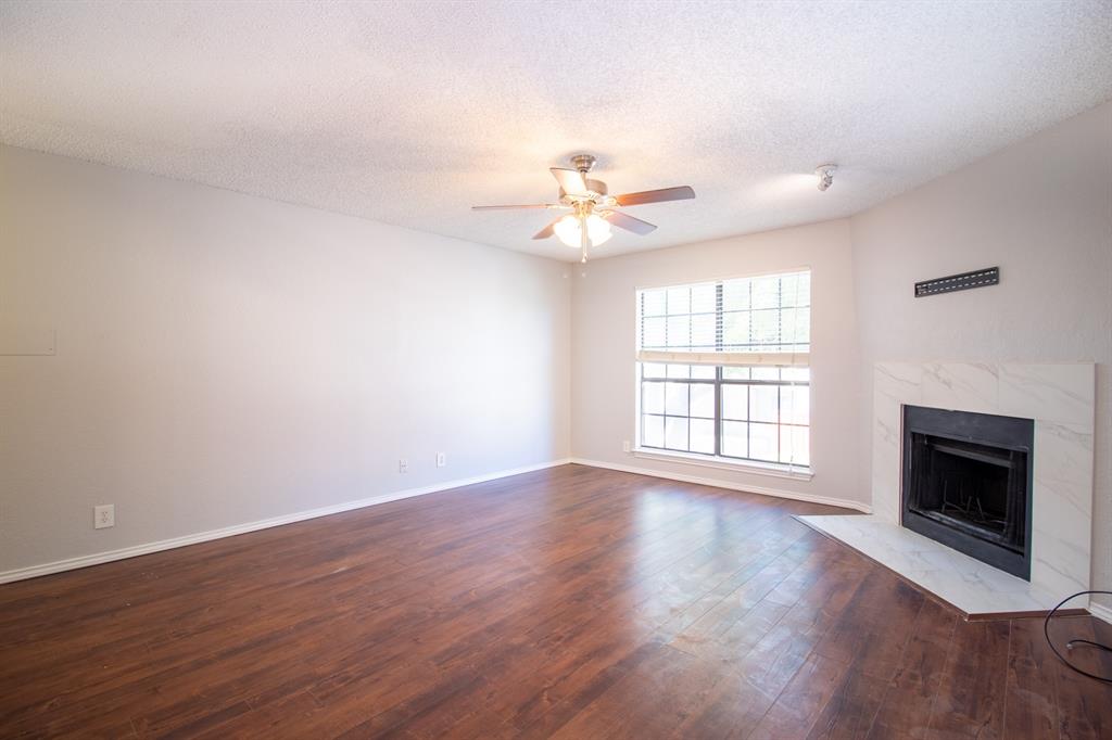 4777 Cedar Springs Road, Unit 4D Dallas, TX 75219 - Photo 2 of 20 a view of an empty room with wooden floor and a window