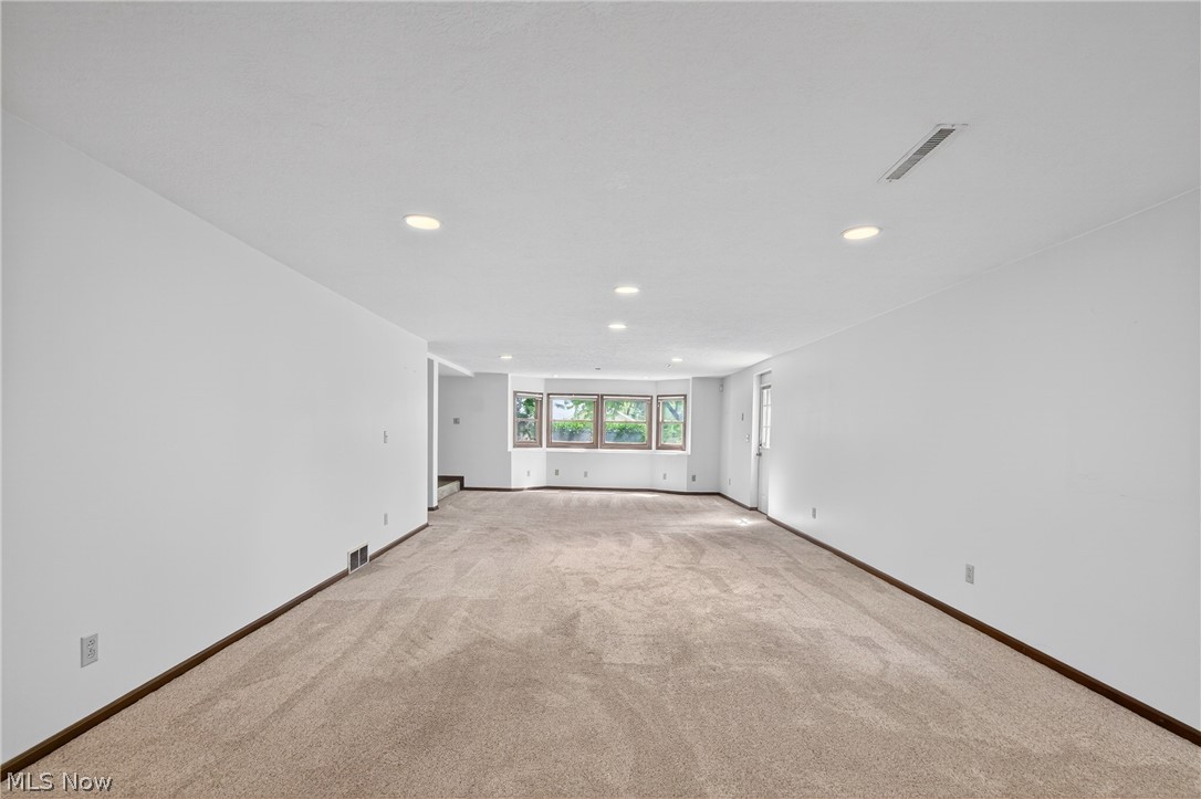 5346 Burlawn Street Northwest Canton, OH 44708 - Photo 26 of 40 Spacious room featuring neutral carpeting, recessed lighting, and a bay window with built-in storage