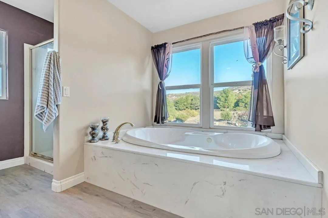 1880 Keyes Road Ramona, CA 92065 - Photo 22 of 49 a bathroom with a granite countertop sink and a window