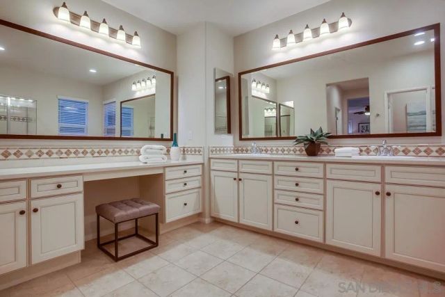 a spacious bathroom with a granite countertop sink vanity and mirror