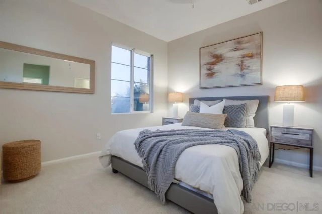 a bedroom with a bed and a painting on the wall