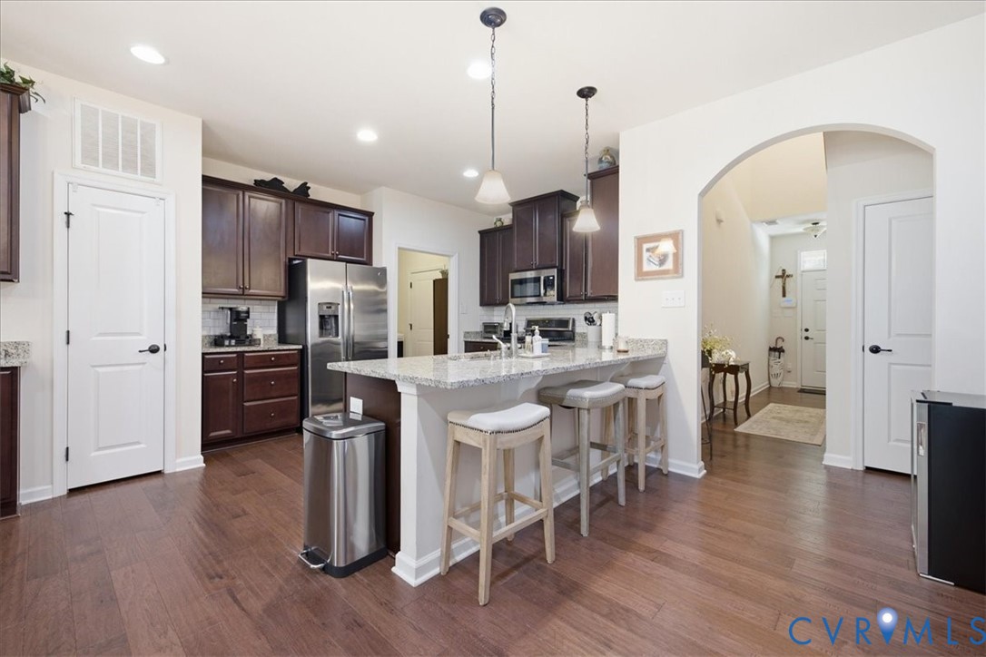 5716 Riverside Place Richmond, VA 23225 - Photo 11 of 33 Kitchen featuring dark wood cabinetry, stainless s