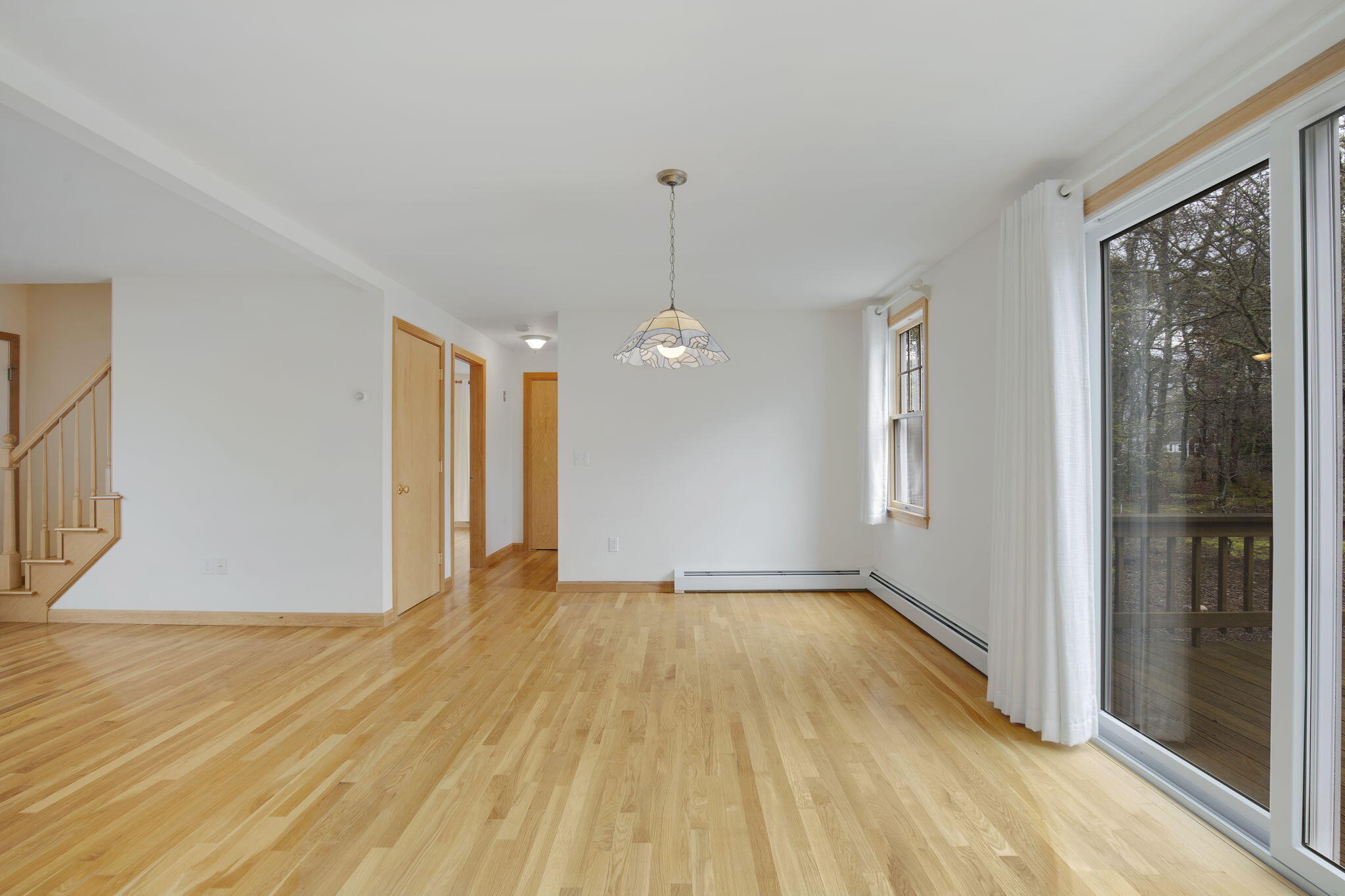 65 Whitney Road Eastham, MA 02642 - Photo 19 of 41 a view of an empty room with glass door and a window