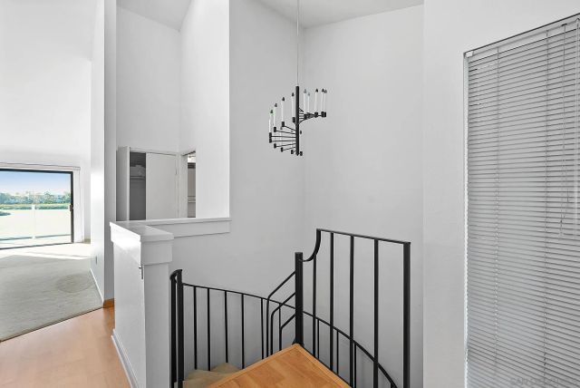 a view of staircase with railing and a window