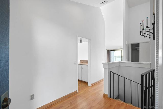 a view of a hallway with wooden floor and entryway
