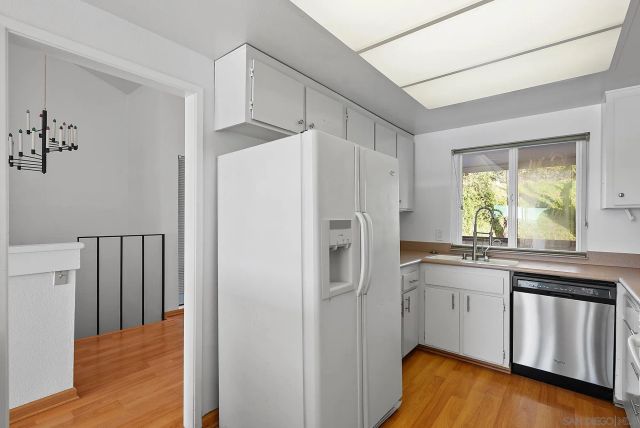 a kitchen with stainless steel appliances a refrigerator and a stove
