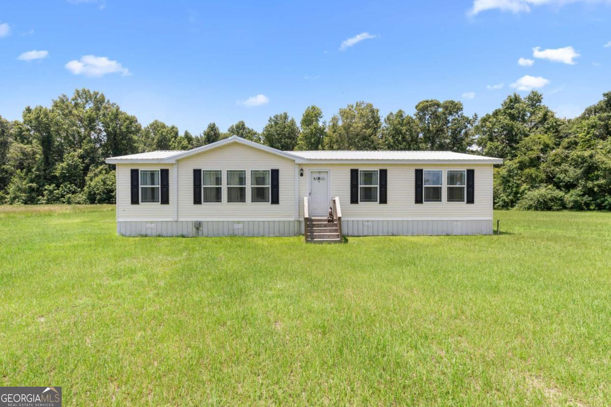3516 Bennetts Landing Road Millen, GA 30442 - Photo 2 of 34 a front view of a house with a garden