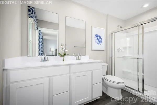 a bathroom with a toilet sink a shower and a mirror