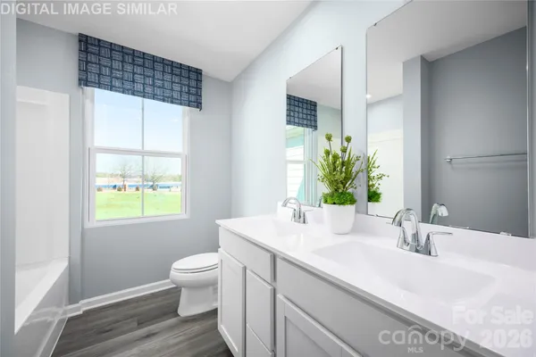 a bathroom with a sink a toilet and a window