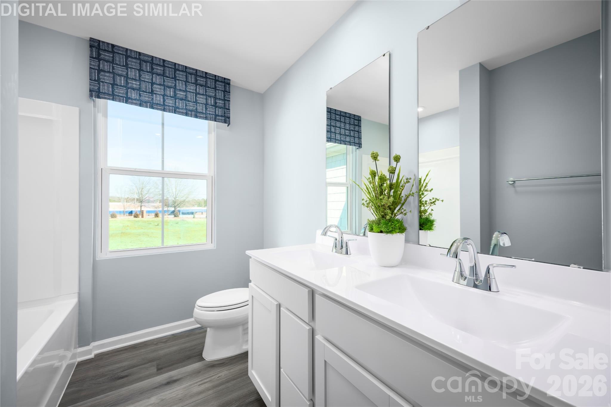 11017 Rococo Lane Charlotte, NC 28214 - Photo 12 of 24 a bathroom with a sink a toilet and a window
