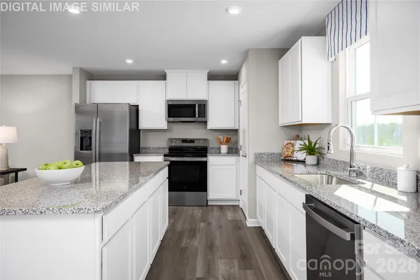 a kitchen with a sink stove and refrigerator