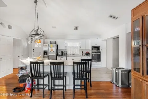 a bed room with a bed and a chandelier