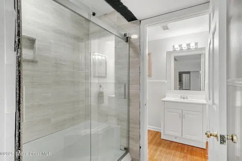 a view of a patio with table and chairs with wooden floor and fence