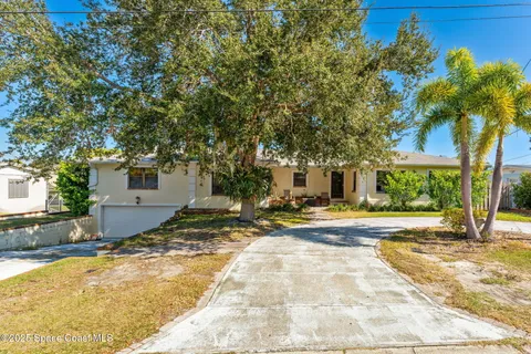 a view of a house with a yard and tree s