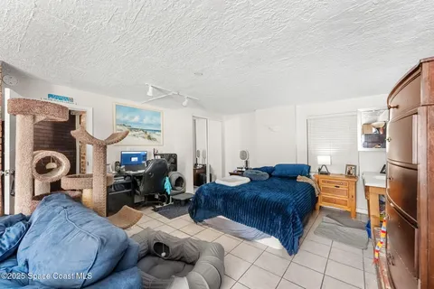 a bed room with a bed and a chandelier