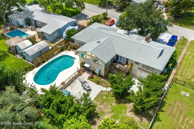 an aerial view of a house with a garden and yard