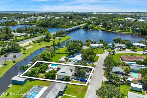 an aerial view of lake residential houses with outdoor space and swimming pool