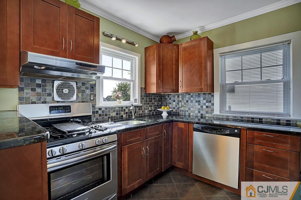 40 Prospect Terrace East Rutherford, NJ 07073 - Photo 4 of 16 a kitchen with granite countertop a stove sink and cabinets