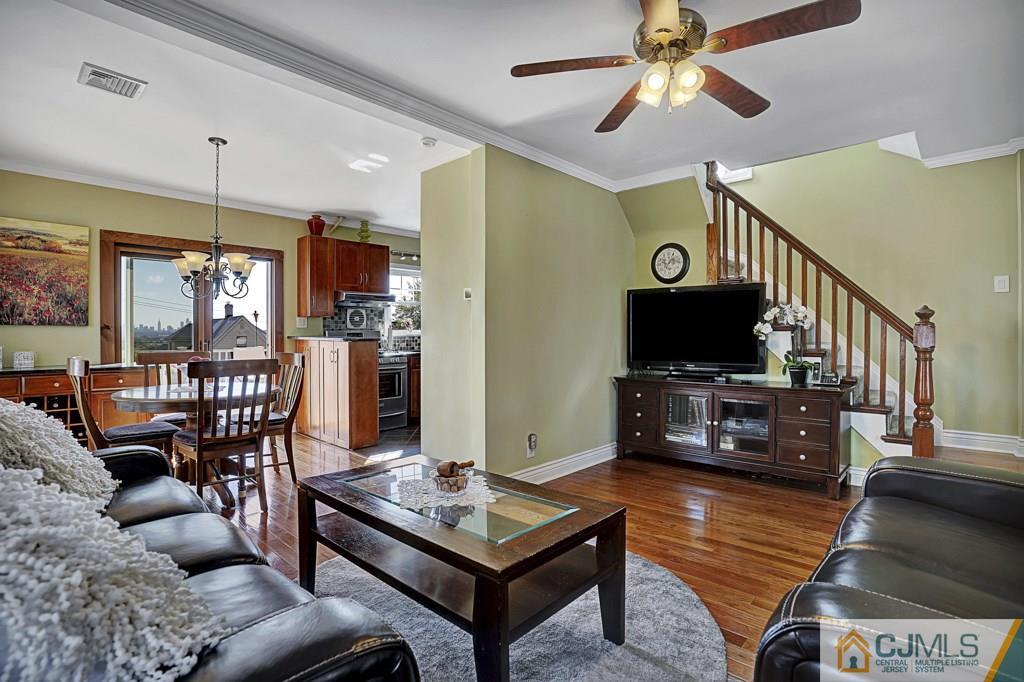 40 Prospect Terrace East Rutherford, NJ 07073 - Photo 6 of 16 a living room with furniture a flat screen tv and kitchen view