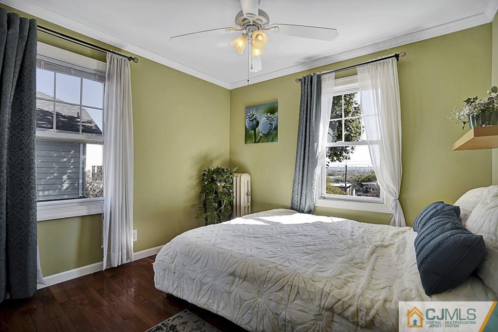 40 Prospect Terrace East Rutherford, NJ 07073 - Photo 10 of 16 a bedroom with a bed and a chandelier