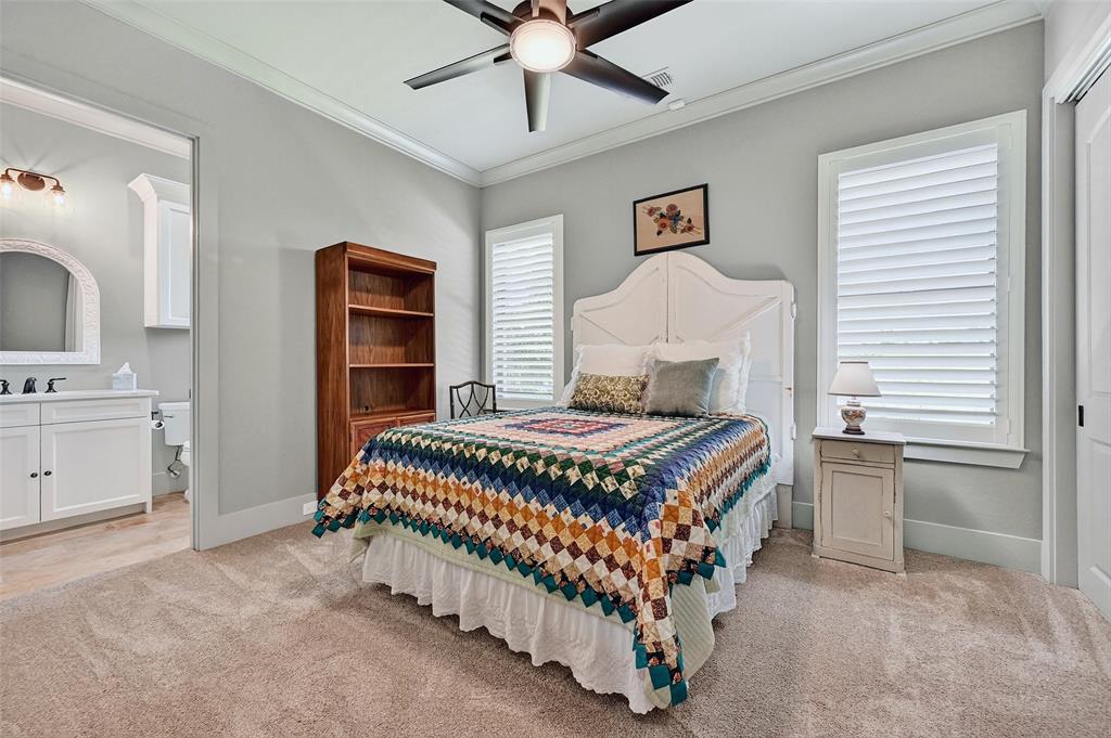 1770 Durning Road Van Alstyne, TX 75495 - Photo 23 of 40 a bedroom with a bed and a chandelier