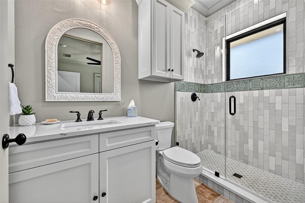 1770 Durning Road Van Alstyne, TX 75495 - Photo 6 of 40 a bathroom with a toilet a sink and mirror