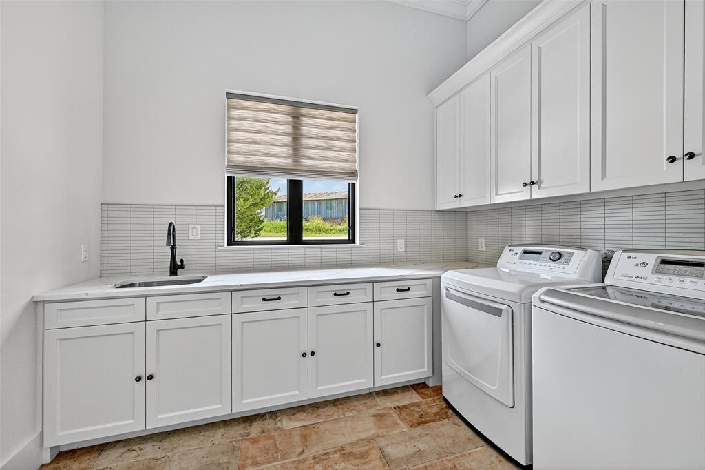 1770 Durning Road Van Alstyne, TX 75495 - Photo 8 of 40 a utility room with cabinets washer and dryer