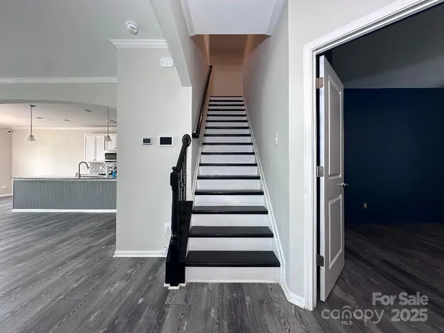 a view of entryway with wooden floor and stairs