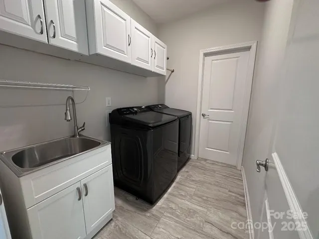 a kitchen with a stove and white cabinets