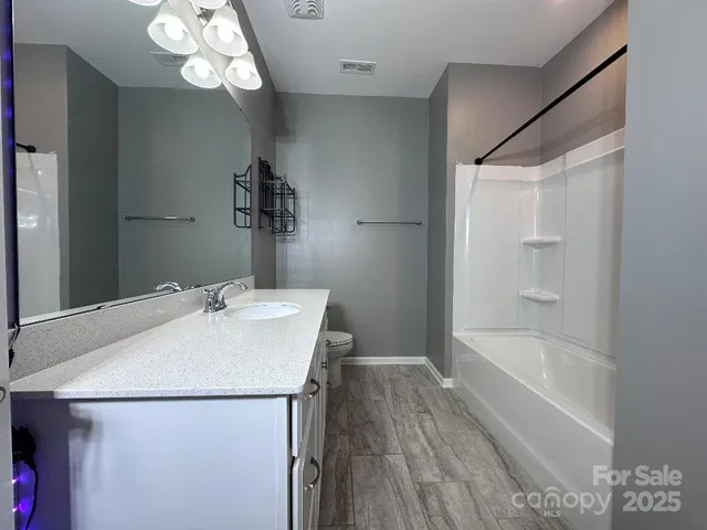 a bathroom with a bathtub a sink and a mirror