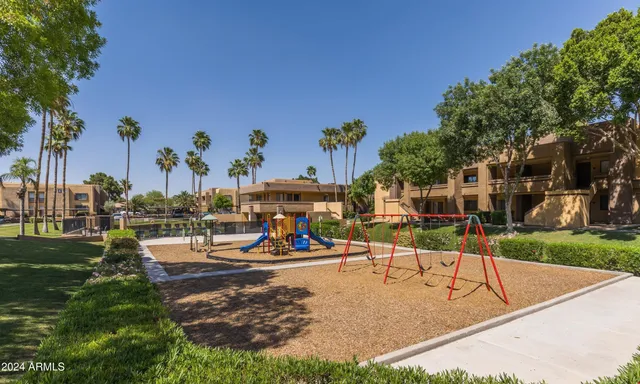 a view of a park with swings and slides