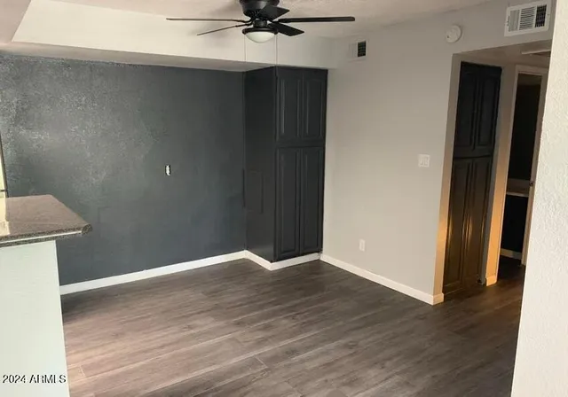a view of a room with wooden floor