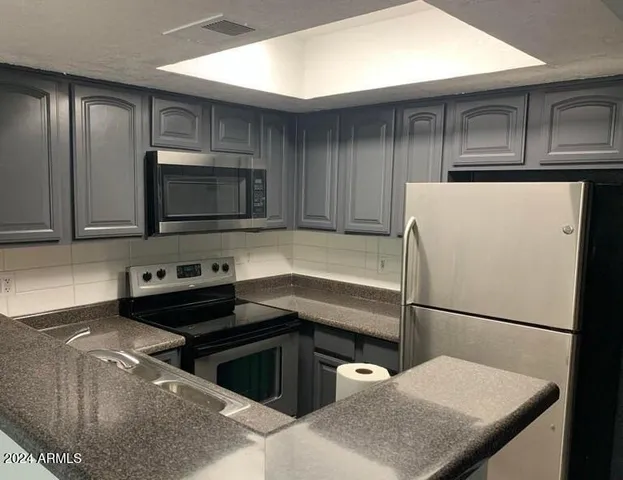 a kitchen with a refrigerator sink and microwave