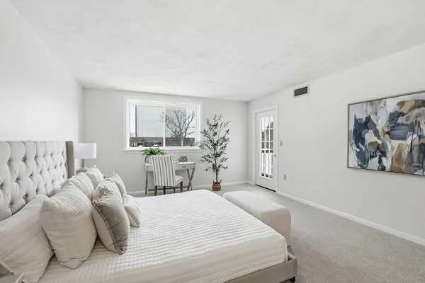 a bedroom with a large bed and a window