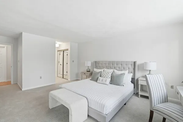 a bedroom with a bed and chair